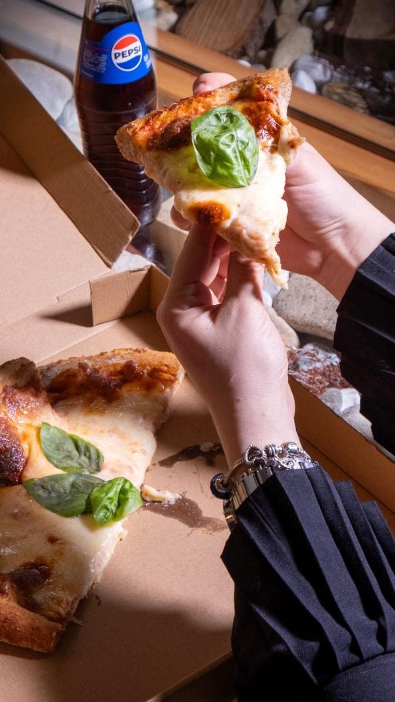 A slice of pizza fresh from the wood-fired oven